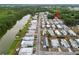 Aerial image showing the property's location in a lakeside community surrounded by lush greenery at 3027 Mimosa Way, Lakeland, FL 33801