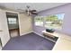 This bedroom boasts natural light, a ceiling fan, and simple decor at 3027 Mimosa Way, Lakeland, FL 33801
