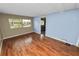 Bedroom with view of large window and neutral paint, plus entry way into home at 3027 Mimosa Way, Lakeland, FL 33801