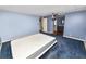 Bedroom with blue walls and carpet and view into the bathroom and closet areas at 3027 Mimosa Way, Lakeland, FL 33801