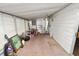 An enclosed porch provides a versatile space with a window view and access to the home's interior at 3027 Mimosa Way, Lakeland, FL 33801