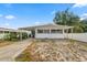 Inviting single-story home featuring a covered parking area and a well-maintained front yard at 3027 Mimosa Way, Lakeland, FL 33801