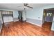 Open living room with wood floors, ceiling fan, washer and dryer hookups and half wall accents at 3027 Mimosa Way, Lakeland, FL 33801