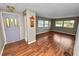 Spacious living room featuring hardwood floors, a decorative clock, and ample natural light at 3027 Mimosa Way, Lakeland, FL 33801