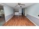 Spacious living room with hardwood floors, a laundry area, and access to a screened porch at 3027 Mimosa Way, Lakeland, FL 33801