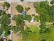 Aerial view of a charming home surrounded by mature trees, offering privacy and a serene setting at 3441 Sherertz Rd, Lakeland, FL 33810