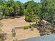 Large backyard with a partial fence line, a wooden trellis, and mature trees at 3441 Sherertz Rd, Lakeland, FL 33810