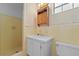 This bathroom features yellow tile, a wooden medicine cabinet, and a walk-in shower at 3441 Sherertz Rd, Lakeland, FL 33810