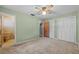 Light-filled bedroom with a ceiling fan and access to bathroom and closets at 3441 Sherertz Rd, Lakeland, FL 33810