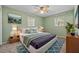 Comfortable bedroom with large windows, a ceiling fan, and stylish decor at 3441 Sherertz Rd, Lakeland, FL 33810