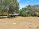 Wide shot of home with mature trees in the front yard at 3441 Sherertz Rd, Lakeland, FL 33810