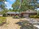 Charming one-story brick home with an attached garage and mature landscaping, offering curb appeal at 3441 Sherertz Rd, Lakeland, FL 33810