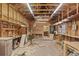 Spacious garage interior with wooden paneling, exposed ceiling beams, and ample workspace potential at 3441 Sherertz Rd, Lakeland, FL 33810
