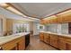 Well-lit kitchen featuring wooden cabinets, black appliances, and brick flooring at 3441 Sherertz Rd, Lakeland, FL 33810