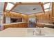 Kitchen showing wooden cabinets, stainless steel appliances, with a view of the brick fireplace at 3441 Sherertz Rd, Lakeland, FL 33810