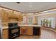 Kitchen showcases black appliances, wooden cabinets, and beautiful brick flooring at 3441 Sherertz Rd, Lakeland, FL 33810