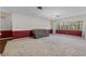 Bright living room with a large window, carpet flooring, and views of mature landscaping at 3441 Sherertz Rd, Lakeland, FL 33810