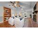 Cozy living room featuring custom built-ins, a brick fireplace, and plush seating for entertaining at 3441 Sherertz Rd, Lakeland, FL 33810