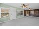 Enclosed sun room includes two ceiling fans, multiple windows, and access to an outdoor deck at 3441 Sherertz Rd, Lakeland, FL 33810
