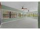 Bright sun room with multiple windows offering scenic views and featuring two ceiling fans at 3441 Sherertz Rd, Lakeland, FL 33810