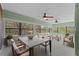 Bright sunroom featuring a dining table, cozy seating area, and large windows showcasing the outdoor landscape at 3441 Sherertz Rd, Lakeland, FL 33810