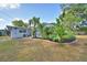 Backyard with tropical landscaping, pool, and cozy home in a lush, green environment at 346 Tanager Ct, Lakeland, FL 33803