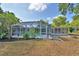Beautiful backyard featuring a screened pool, lush landscaping, and inviting outdoor space for relaxation and entertainment at 346 Tanager Ct, Lakeland, FL 33803