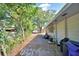 Side yard with partial fence and lush greenery at 346 Tanager Ct, Lakeland, FL 33803