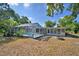 This spacious backyard boasts a screened pool, fire pit, and well-maintained lawn, perfect for outdoor enjoyment at 346 Tanager Ct, Lakeland, FL 33803