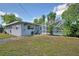 Backyard showcasing the pool and tropical plants, complemented by a well-maintained lawn at 346 Tanager Ct, Lakeland, FL 33803
