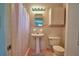 Charming bathroom featuring retro tiling, a pedestal sink, and a classic shower at 346 Tanager Ct, Lakeland, FL 33803