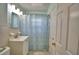 Bright bathroom featuring a shower with a patterned curtain and white single sink vanity at 346 Tanager Ct, Lakeland, FL 33803