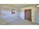 Cozy bedroom with neutral carpet, a window, and a closet with a fabric curtain at 346 Tanager Ct, Lakeland, FL 33803