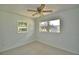 Bedroom featuring two windows letting in natural light and a ceiling fan for comfort at 346 Tanager Ct, Lakeland, FL 33803