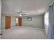 View of the carpeted bedroom with a ceiling fan, art, and curtains, showcasing its size and natural light at 346 Tanager Ct, Lakeland, FL 33803