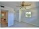 Bright bedroom with a ceiling fan, closet, and view to the hallway, and large window for natural light at 346 Tanager Ct, Lakeland, FL 33803