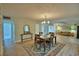 Open-concept dining room with stylish chandelier and hardwood floors at 346 Tanager Ct, Lakeland, FL 33803