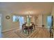 Open-concept dining room with stylish chandelier and hardwood floors and view of the kitchen at 346 Tanager Ct, Lakeland, FL 33803