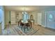 Open-concept dining room with stylish chandelier and hardwood floors at 346 Tanager Ct, Lakeland, FL 33803