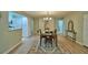Open-concept dining room with stylish chandelier and hardwood floors and view of the kitchen at 346 Tanager Ct, Lakeland, FL 33803