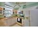 Well-lit kitchen featuring ample cabinetry, modern appliances, and a charming tile backsplash at 346 Tanager Ct, Lakeland, FL 33803
