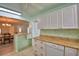 Updated kitchen with breakfast bar and stainless steel dishwasher overlooking the dining room at 346 Tanager Ct, Lakeland, FL 33803