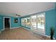 Spacious living room with large windows offering picturesque views of the pool area at 346 Tanager Ct, Lakeland, FL 33803