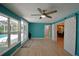 Open-concept living room with sliding barn doors, large windows overlooking the pool, and access to the kitchen at 346 Tanager Ct, Lakeland, FL 33803