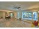 Bright, open-concept living room featuring hardwood floors and large windows at 346 Tanager Ct, Lakeland, FL 33803