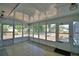 Enclosed patio boasts tile flooring and multiple windows providing natural light and outdoor views at 346 Tanager Ct, Lakeland, FL 33803