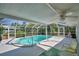 Screened pool with ceiling fan, lounge chairs, and a tropical rug create a comfortable and stylish outdoor retreat at 346 Tanager Ct, Lakeland, FL 33803