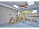 Enclosed screened porch with wicker furniture, skylights, a ceiling fan and a view of the backyard at 346 Tanager Ct, Lakeland, FL 33803