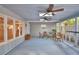 Enclosed screened porch with wicker furniture and a view of the kitchen and dining room through windows at 346 Tanager Ct, Lakeland, FL 33803
