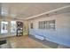 Bright sunroom with tile floors, windows, shelving units and a door to the outside at 346 Tanager Ct, Lakeland, FL 33803